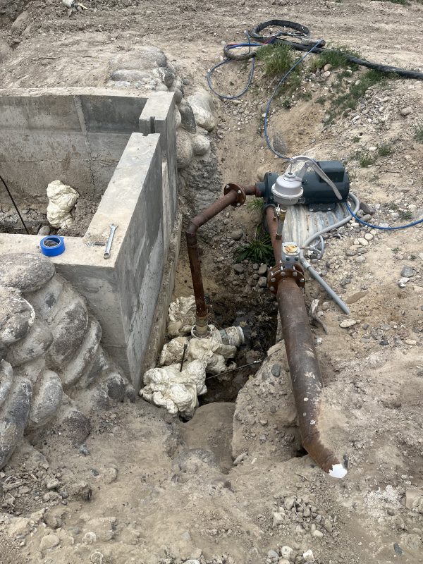 technicians working beside the concrete dam excavation (image 2)