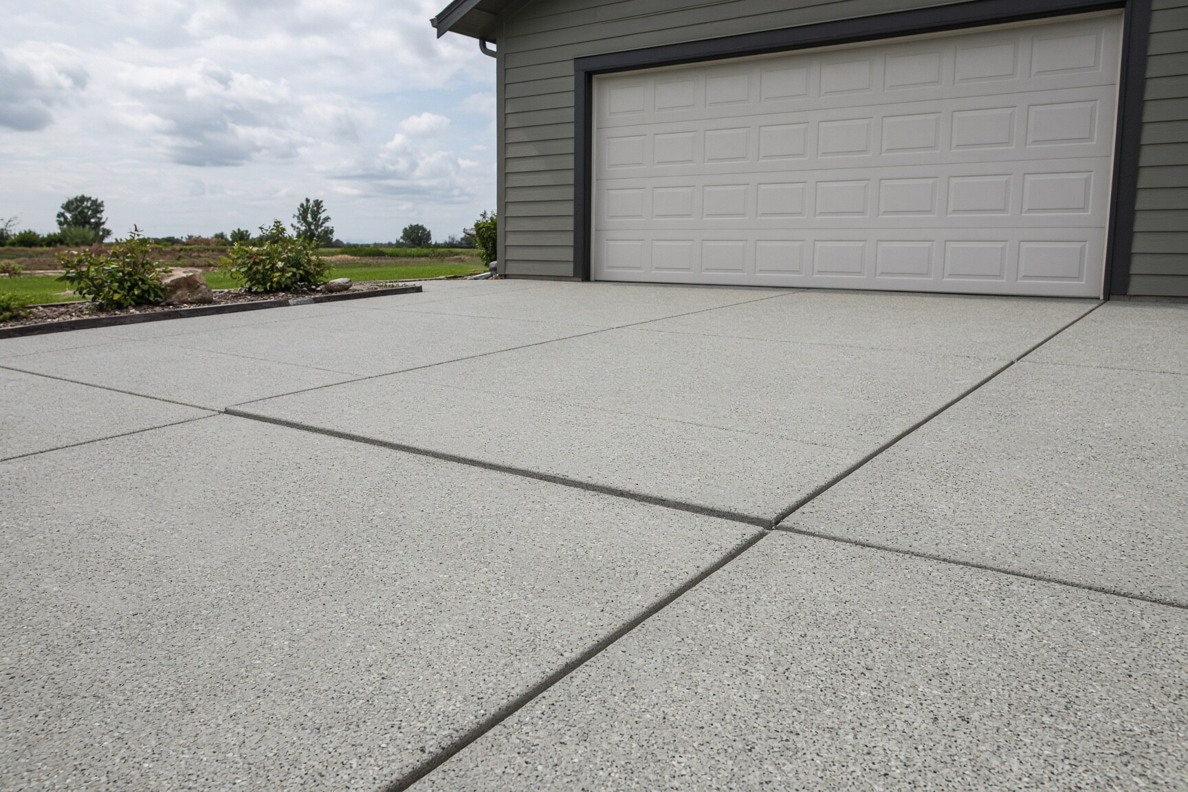 Residential concrete driveway and garage apron with visible slab joints