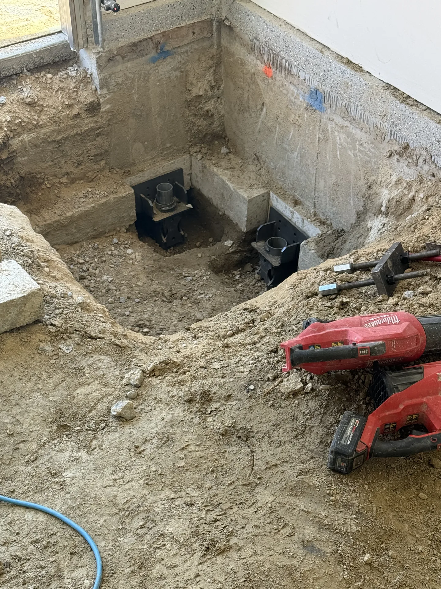 Foundation pier brackets installed on an interior concrete footing
